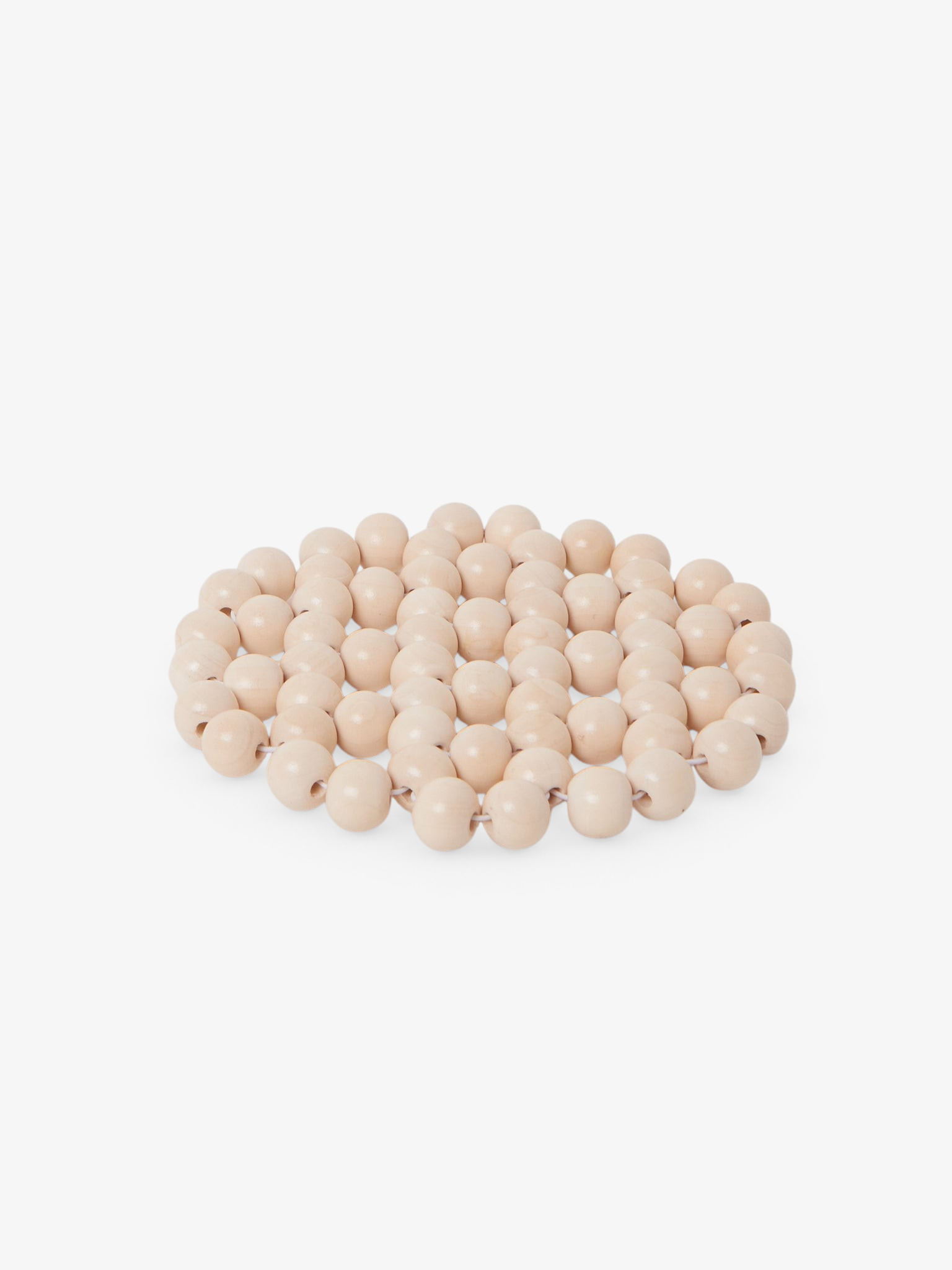 Sommer Larco beaded trivet in cream tofu color, a handmade circular heat-resistant coaster for tabletop decor.