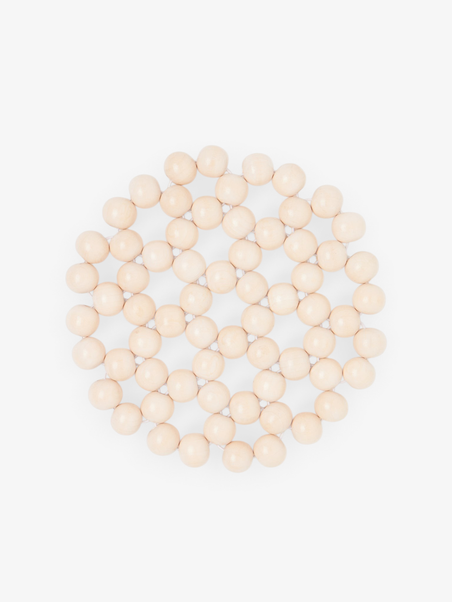 Sommer Larco Tofu beaded trivet featuring a circular pattern of cream-colored lacquered beads for heat protection.