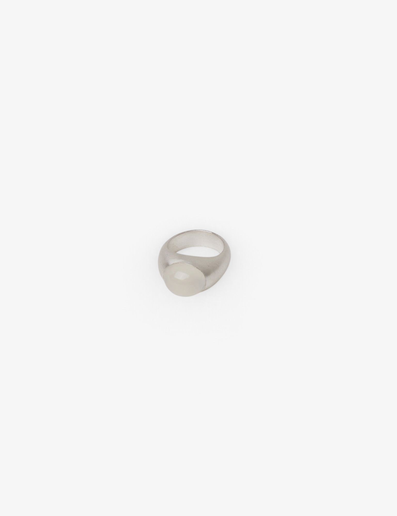 Sommer Dunton Ellerkamp sterling silver ring featuring a smooth white moonstone cabochon on a hand-carved band.
