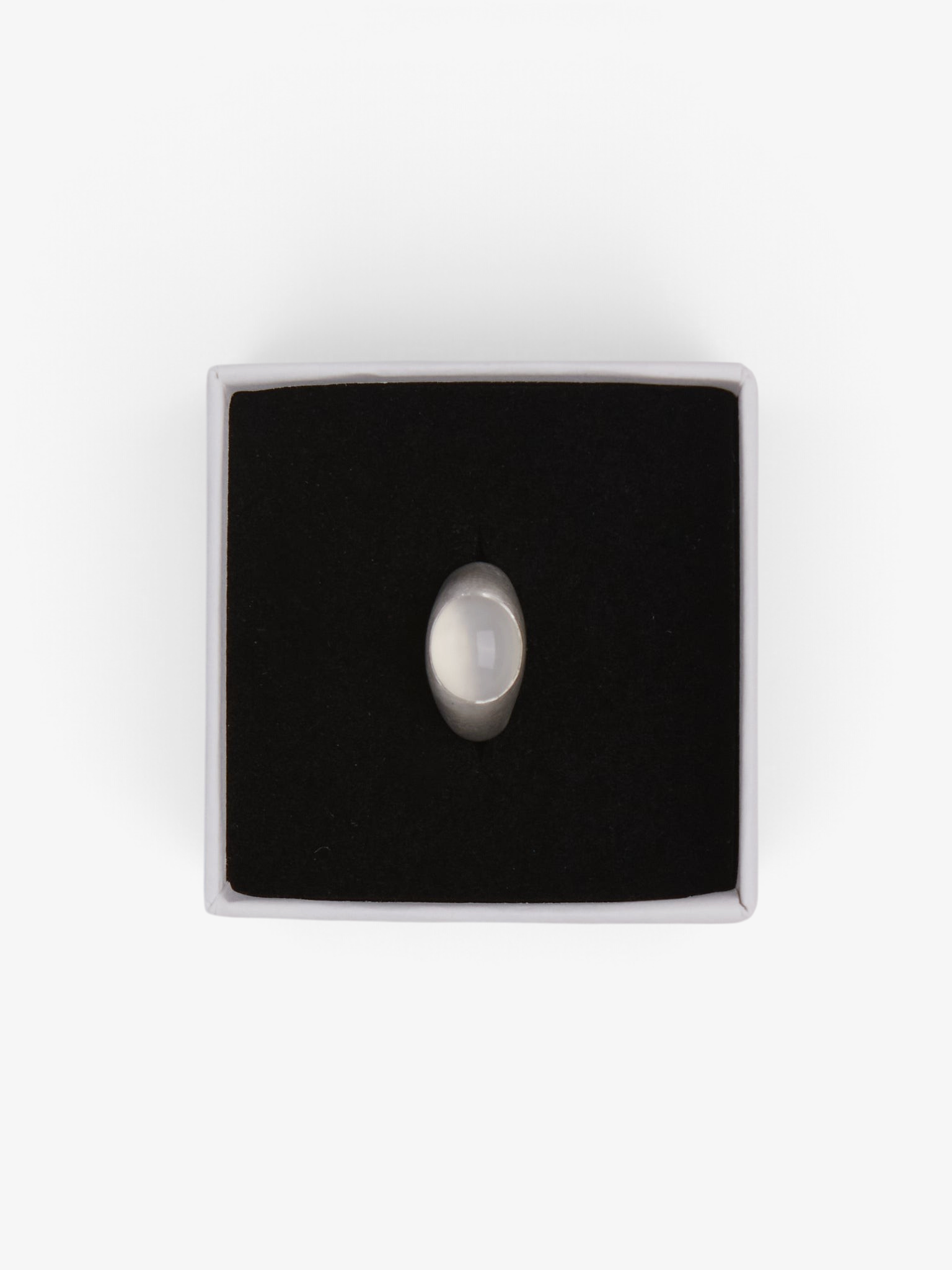 Sommer Dunton Ellerkamp sterling silver ring featuring a smooth white moonstone in a black jewelry gift box
