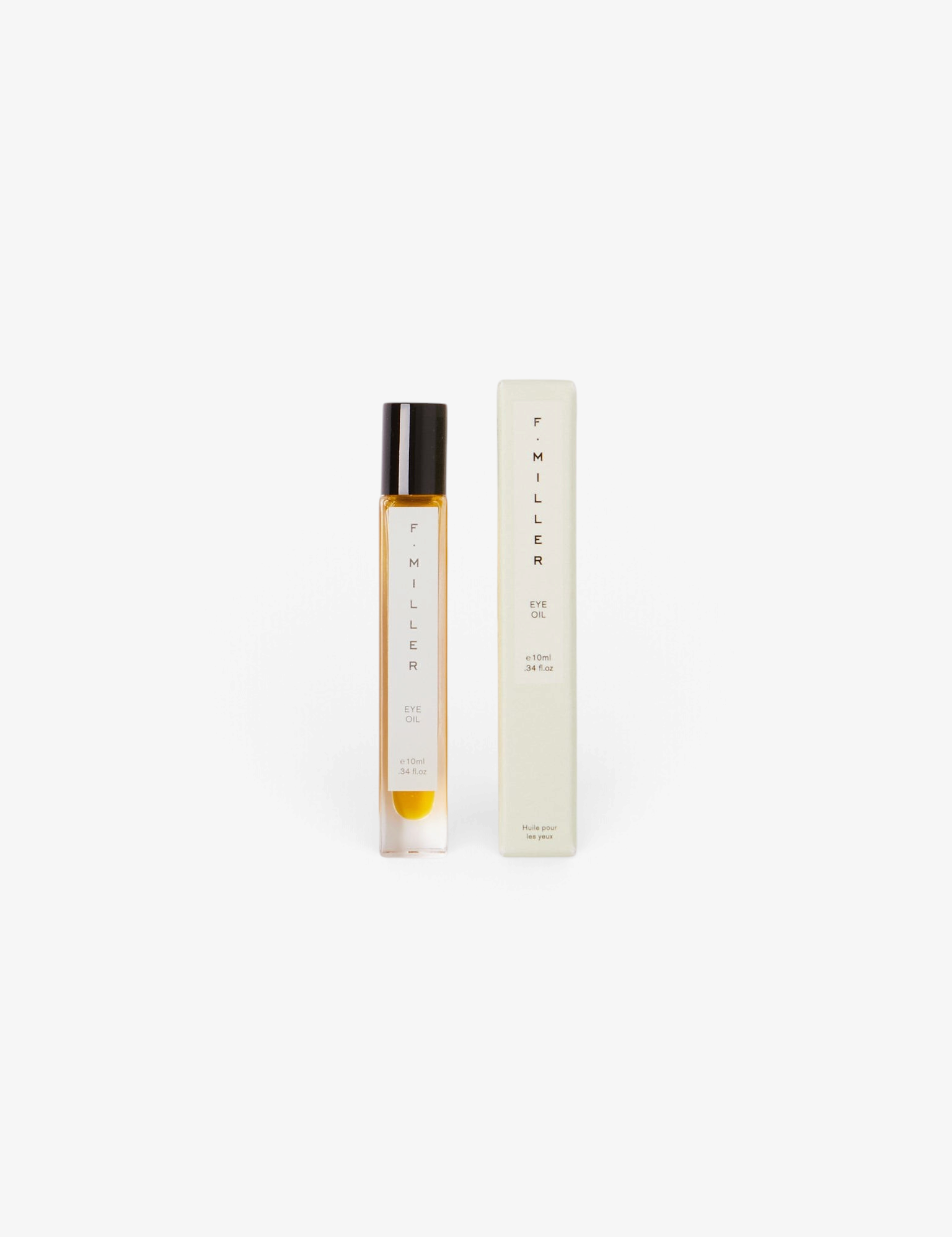 Sommer F. Miller Eye Oil in a glass roller bottle with its light green packaging box on a neutral background.