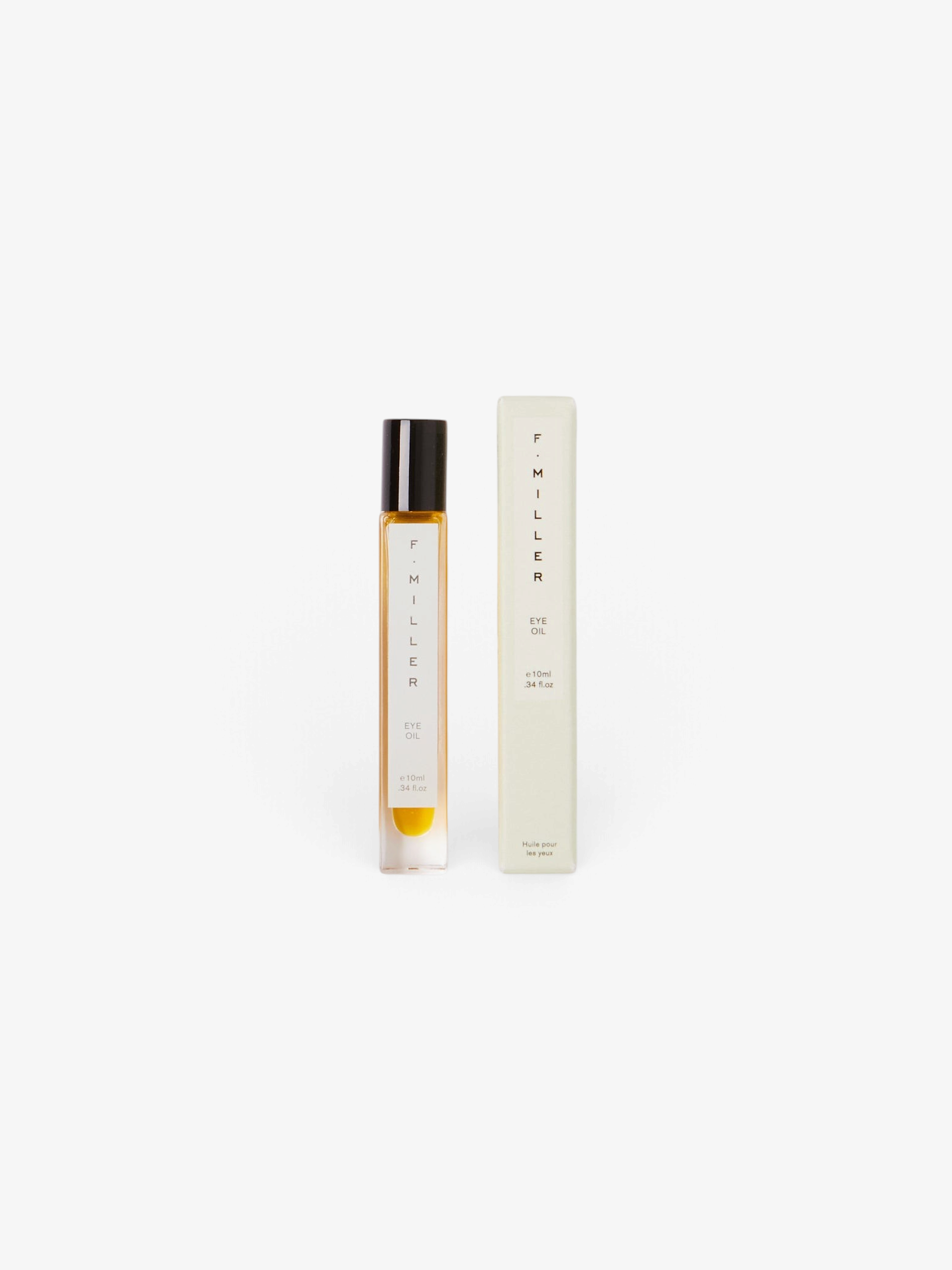 Sommer F. Miller Eye Oil in a glass roller bottle with its light green packaging box on a neutral background.
