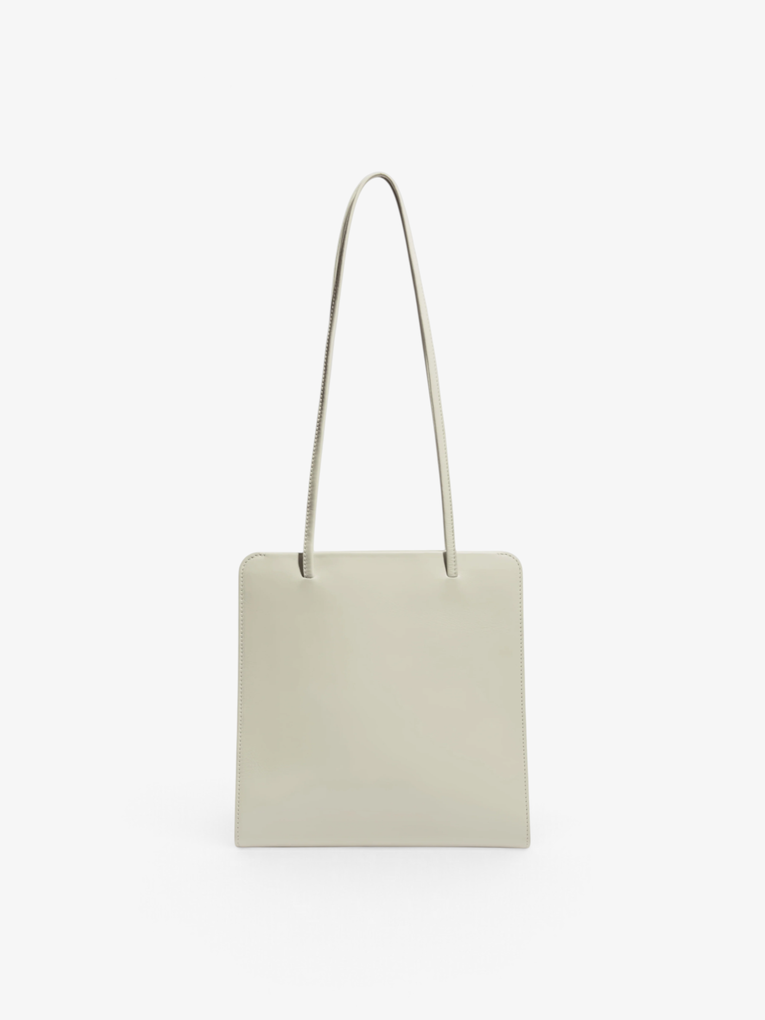 Sommer Lisse Bag in tofu cream calf leather with slim ribbon straps and a minimalist square silhouette.