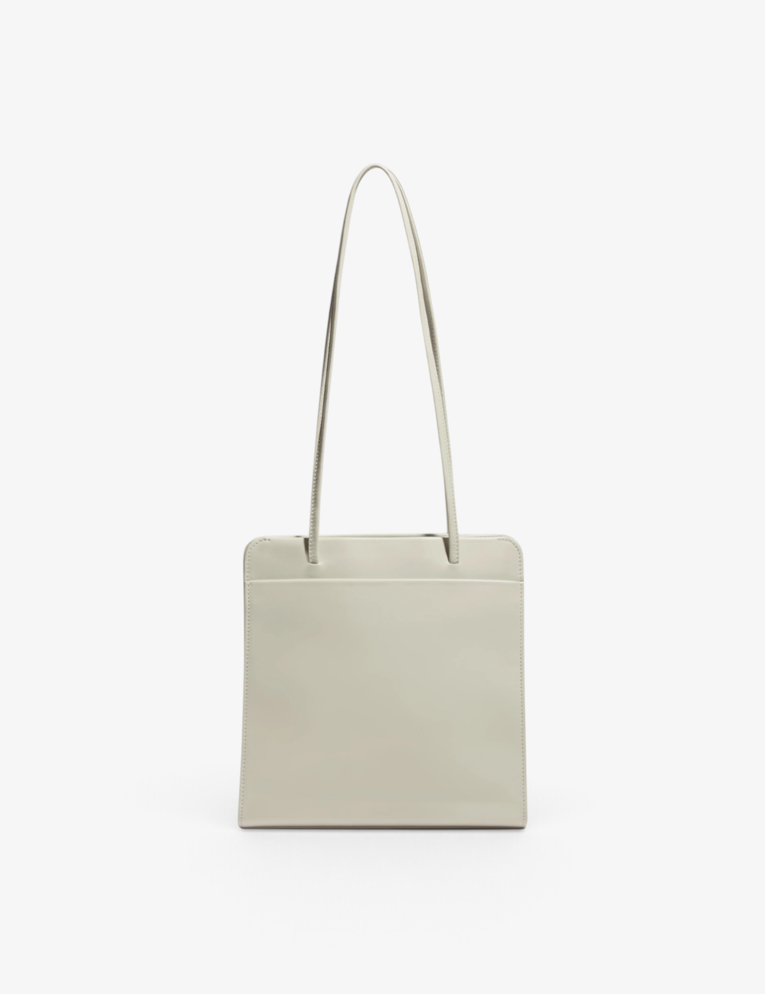 Sommer Lisse Bag in tofu cream calf leather with slim shoulder straps and a minimalist rectangular silhouette.