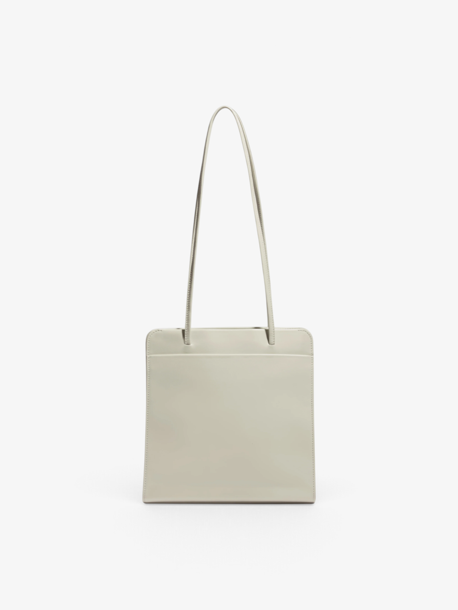 Sommer Lisse Bag in tofu cream calf leather with slim shoulder straps and a minimalist rectangular silhouette.